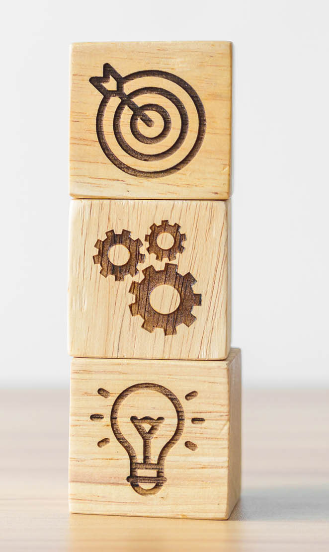 dartboard above Gear and Lightbulb icon block on desk. business planning process, goal, strategy, target, mission, action, objective, teamwork and idea concept