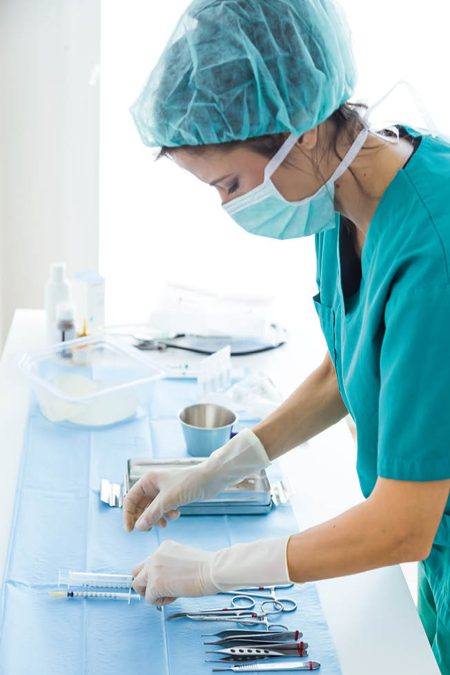 Portrait of doctor with many kind of medical equipment manage for to start operation in operating room 