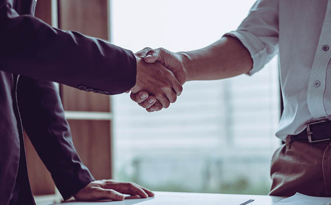 Middle age partner lawyers attorneys shaking hands after discussing a contract agreement done, Asian people 