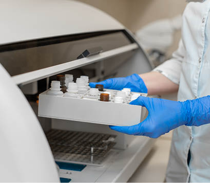 Laboratory technician test blood in automatic blood sample analyzer