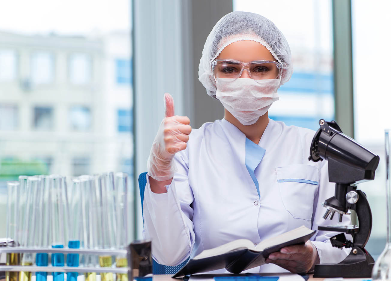 Young student working with chemical solutions in lab