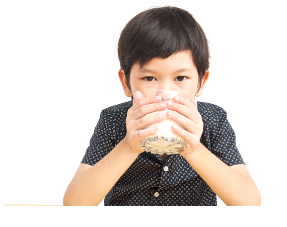 Asian boy is drinking a glass of milk over white background