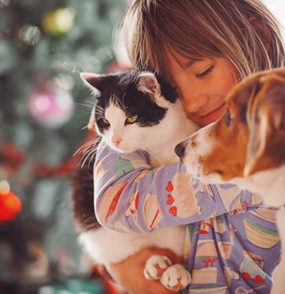 The pretty girl embarcing cat and dog