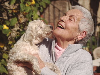Senior woman playing with her dog
