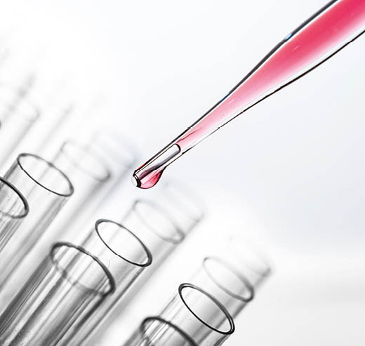 Drop the pink chemicals into the beaker 