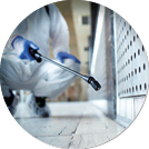 Unrecognizable person in white chemical protection suit doing disinfection of public areas to stop spreading highly contagious corona virus 