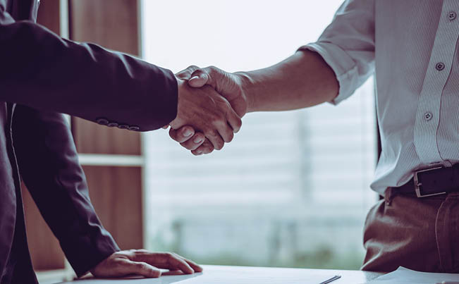 Middle age partner lawyers attorneys shaking hands after discussing a contract agreement done, Asian people 