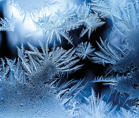 Beautiful frost pattern on a window with blurred background